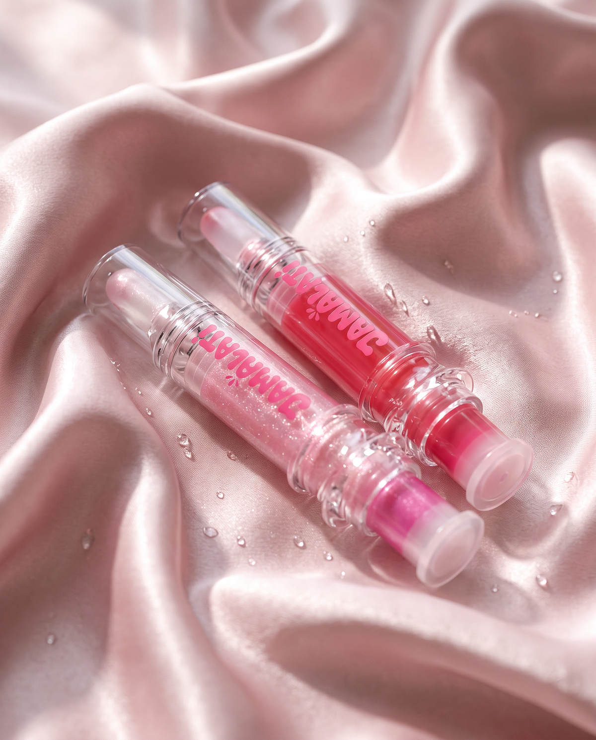 Jamalati lip plumpers on pink satin